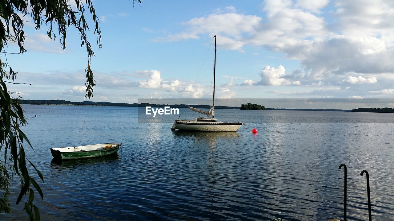 Boats moored on sea against sky