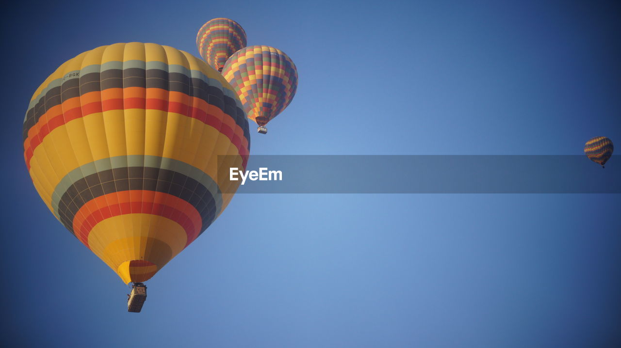 Low angle view of hot air balloons against sky