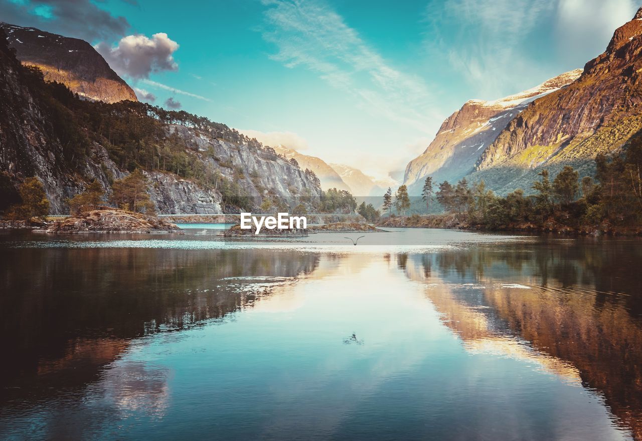 Scenic view of lake and mountains against sky