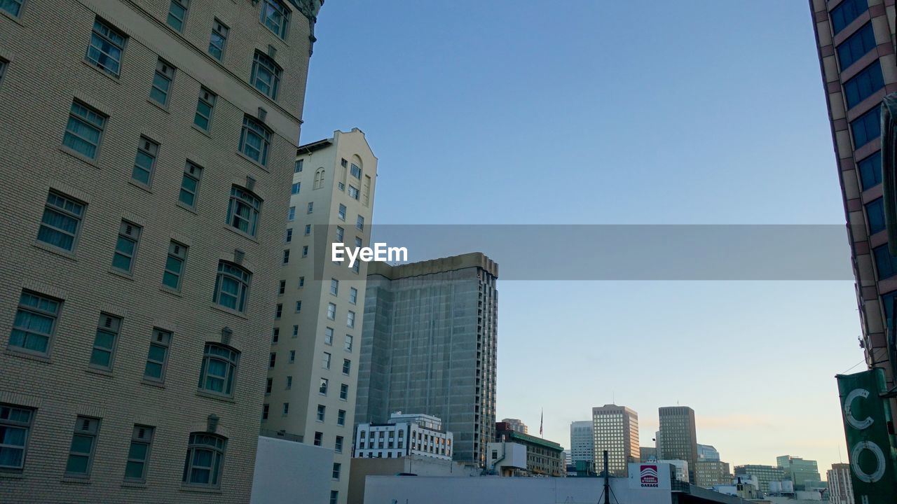 LOW ANGLE VIEW OF CITY AGAINST CLEAR SKY