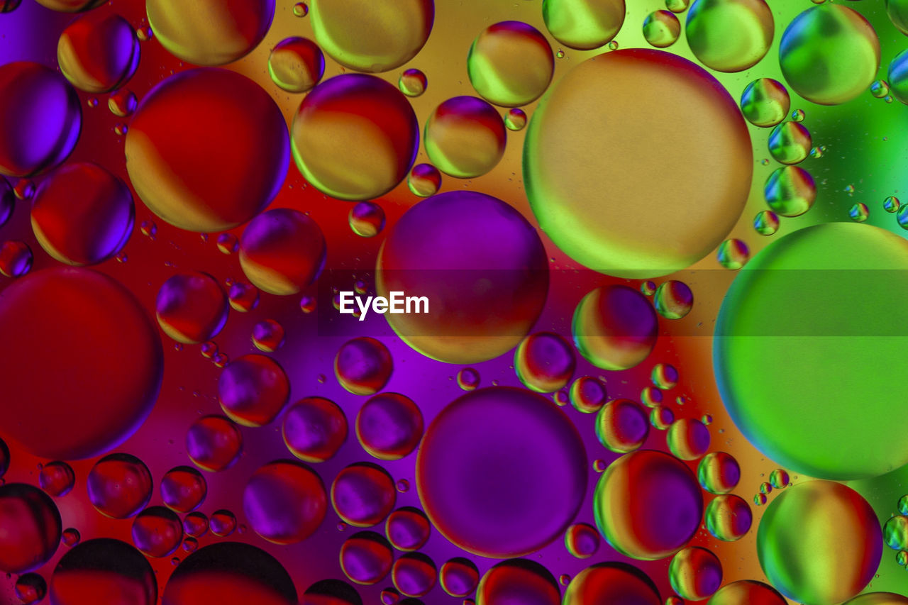 Full frame shot of bubbles in multi colored liquid