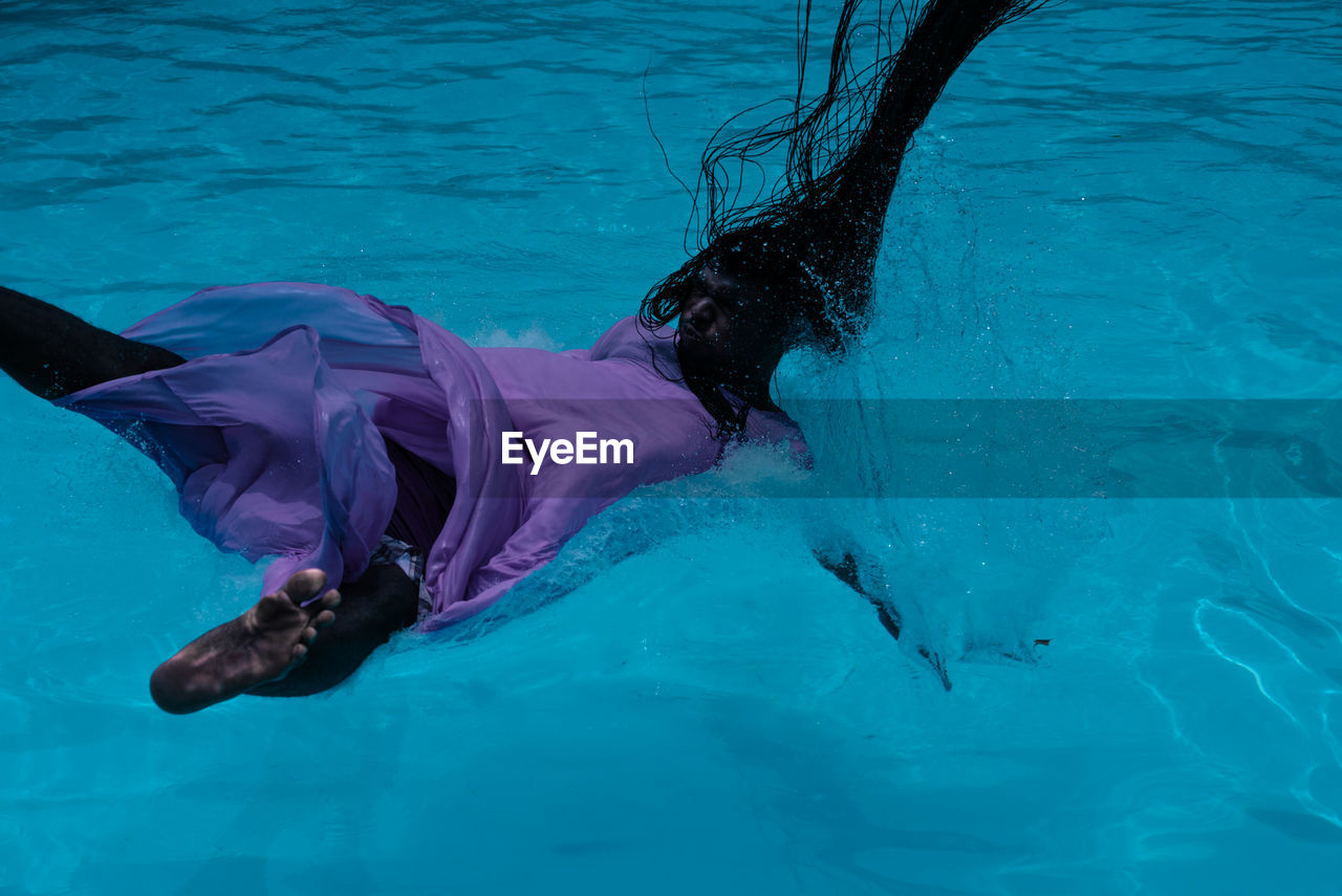 Woman falling in swimming pool
