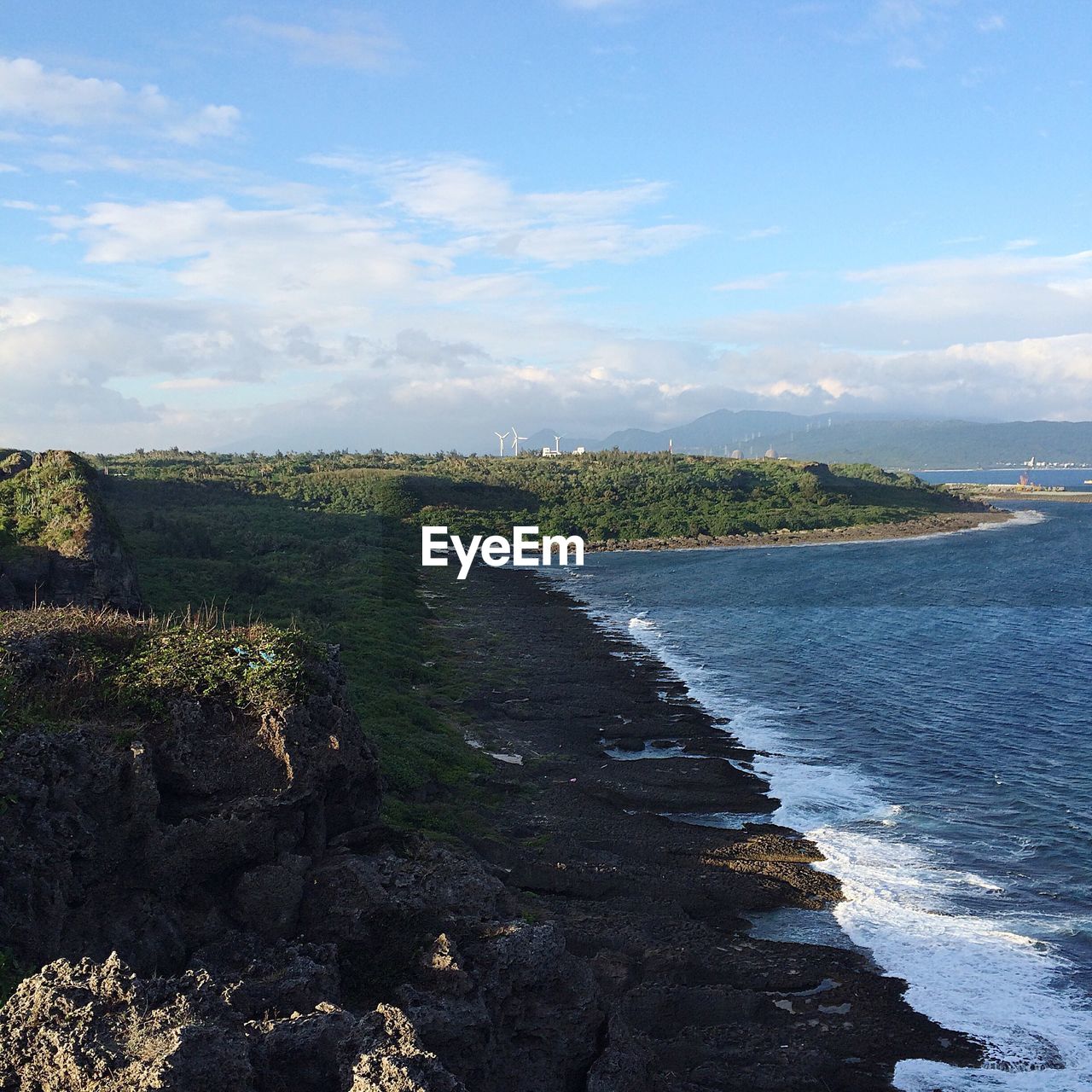 VIEW OF CALM BEACH AGAINST SKY