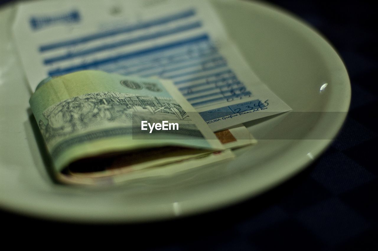 Receipt and money on plate