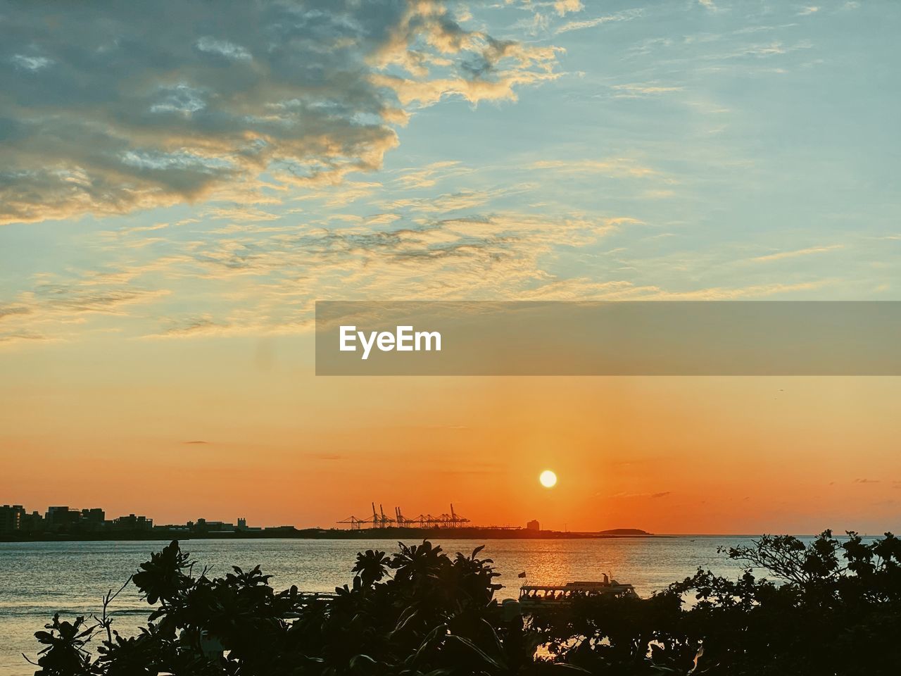SCENIC VIEW OF SUNSET OVER SEA
