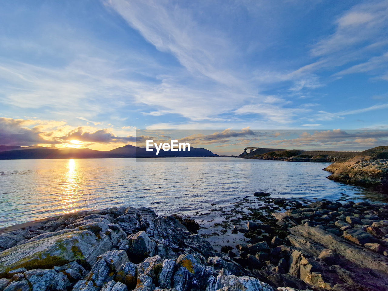 water, sky, shore, scenics - nature, sea, cloud, beauty in nature, body of water, coast, nature, ocean, horizon, sunset, landscape, rock, land, reflection, environment, tranquility, mountain, beach, travel destinations, tranquil scene, dusk, bay, travel, no people, outdoors, sunlight, wave, coastline, sun, idyllic, seascape, tourism, dramatic sky, blue, holiday, non-urban scene, trip, evening