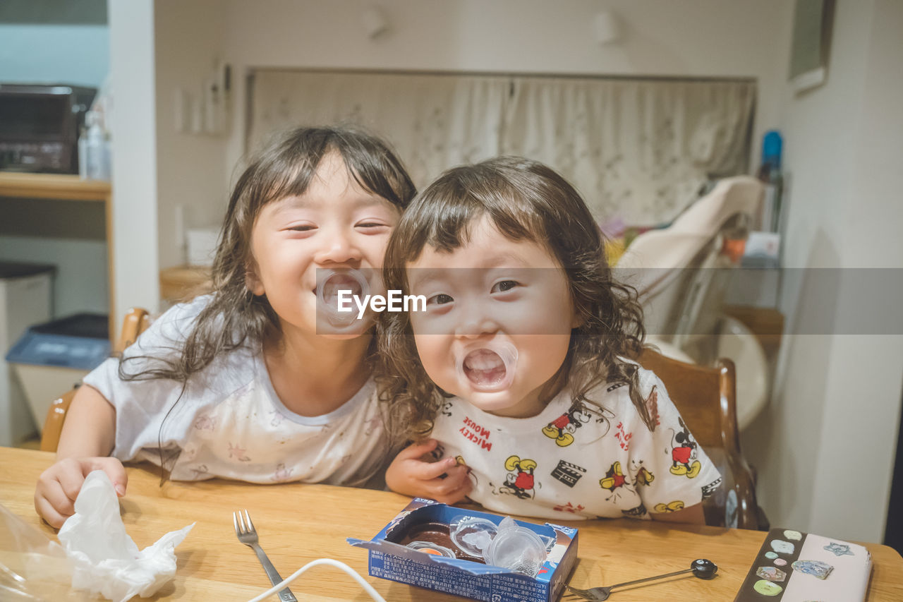 Portrait of siblings at home