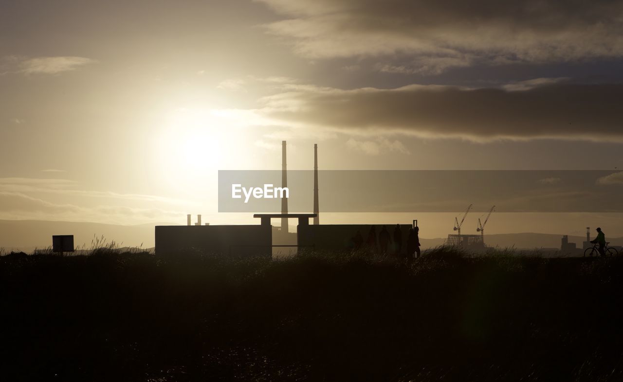 Silhouette built structure against sky during sunset