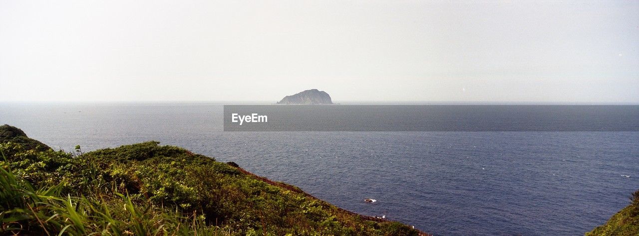 sea, water, horizon, coast, scenics - nature, land, sky, beauty in nature, ocean, cliff, nature, environment, beach, tranquility, horizon over water, travel destinations, landscape, travel, shore, tranquil scene, fog, no people, body of water, tourism, terrain, coastline, seascape, outdoors, plant, bay, rock, non-urban scene, architecture, panoramic, island, idyllic, day, trip, vacation, hill, holiday, morning, bay of water, social issues, tower, built structure, grass