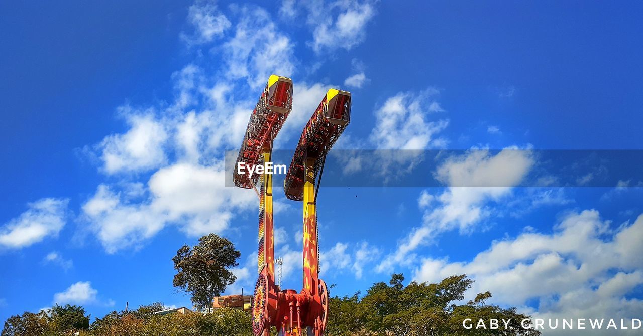 LOW ANGLE VIEW OF CAROUSEL AGAINST SKY