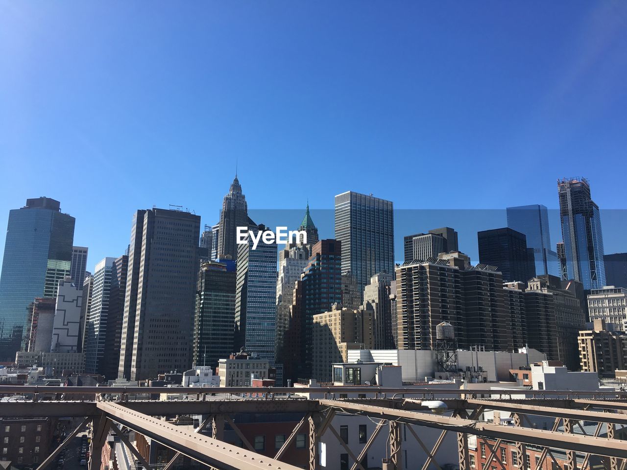 Cityscape against clear blue sky