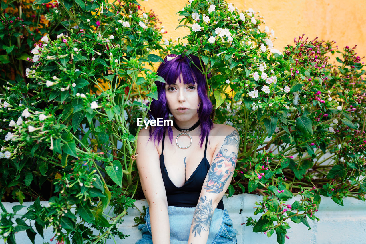 Thoughtful woman sitting alone outdoors. young worried in backyard