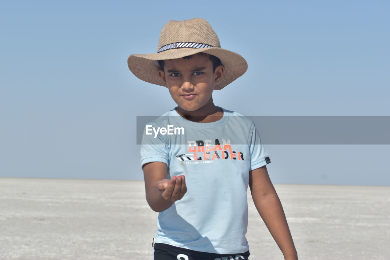 Portrait of boy standing at beach