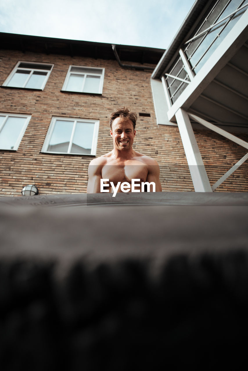 Mature man exercising in backyard