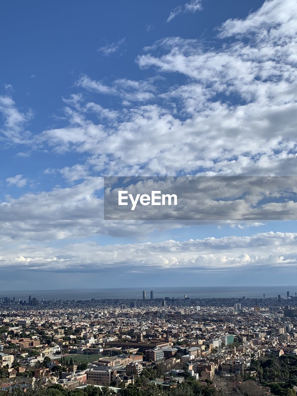 HIGH ANGLE VIEW OF ILLUMINATED CITY AGAINST SKY