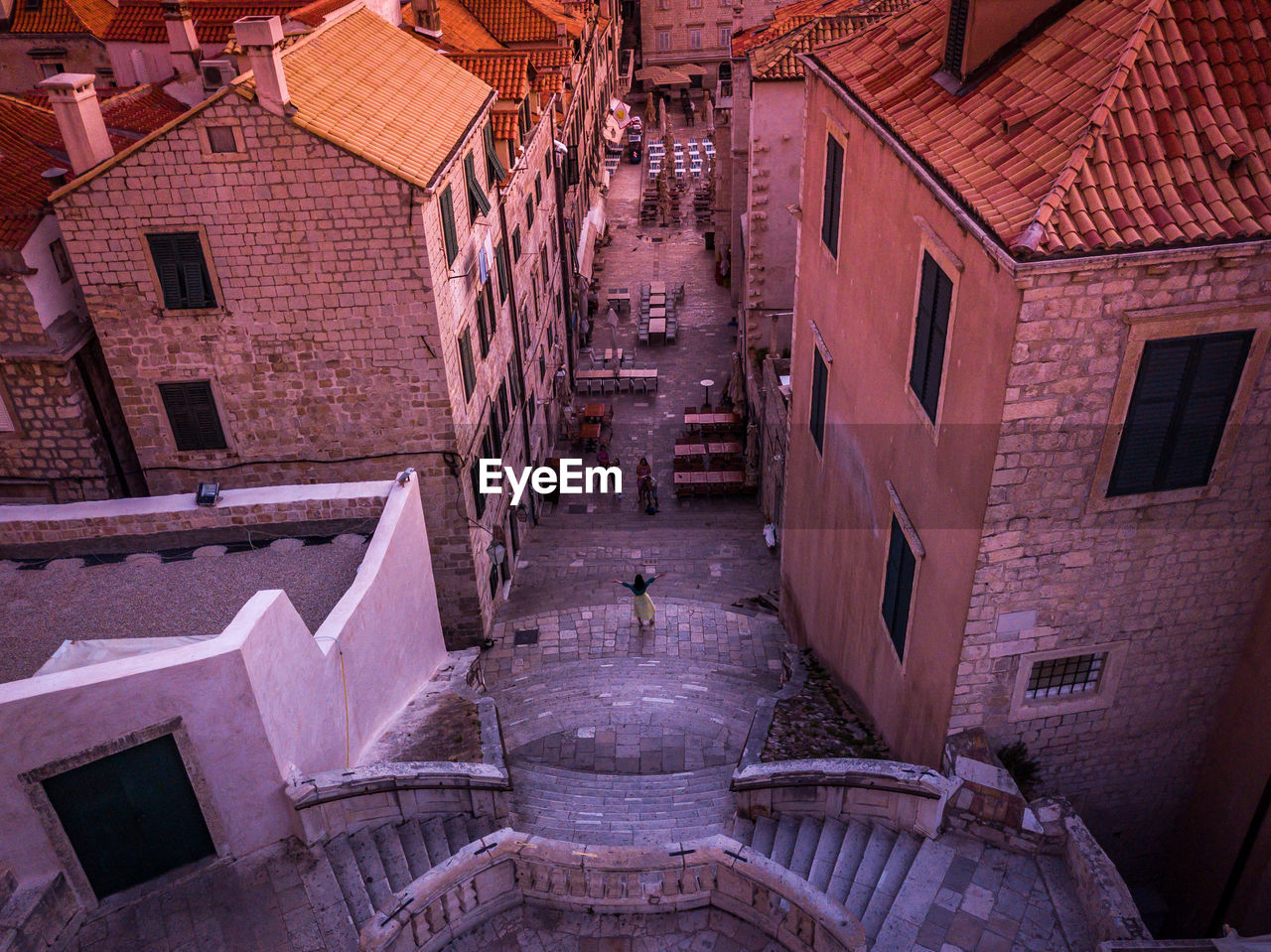 HIGH ANGLE VIEW OF STREET AMIDST BUILDINGS