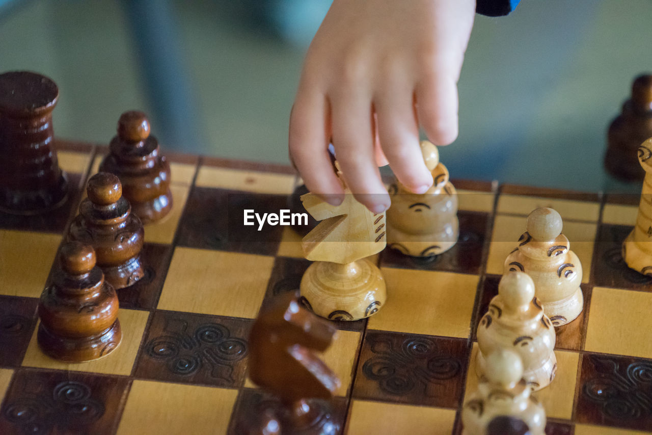 Close-up of baby playing chess at home