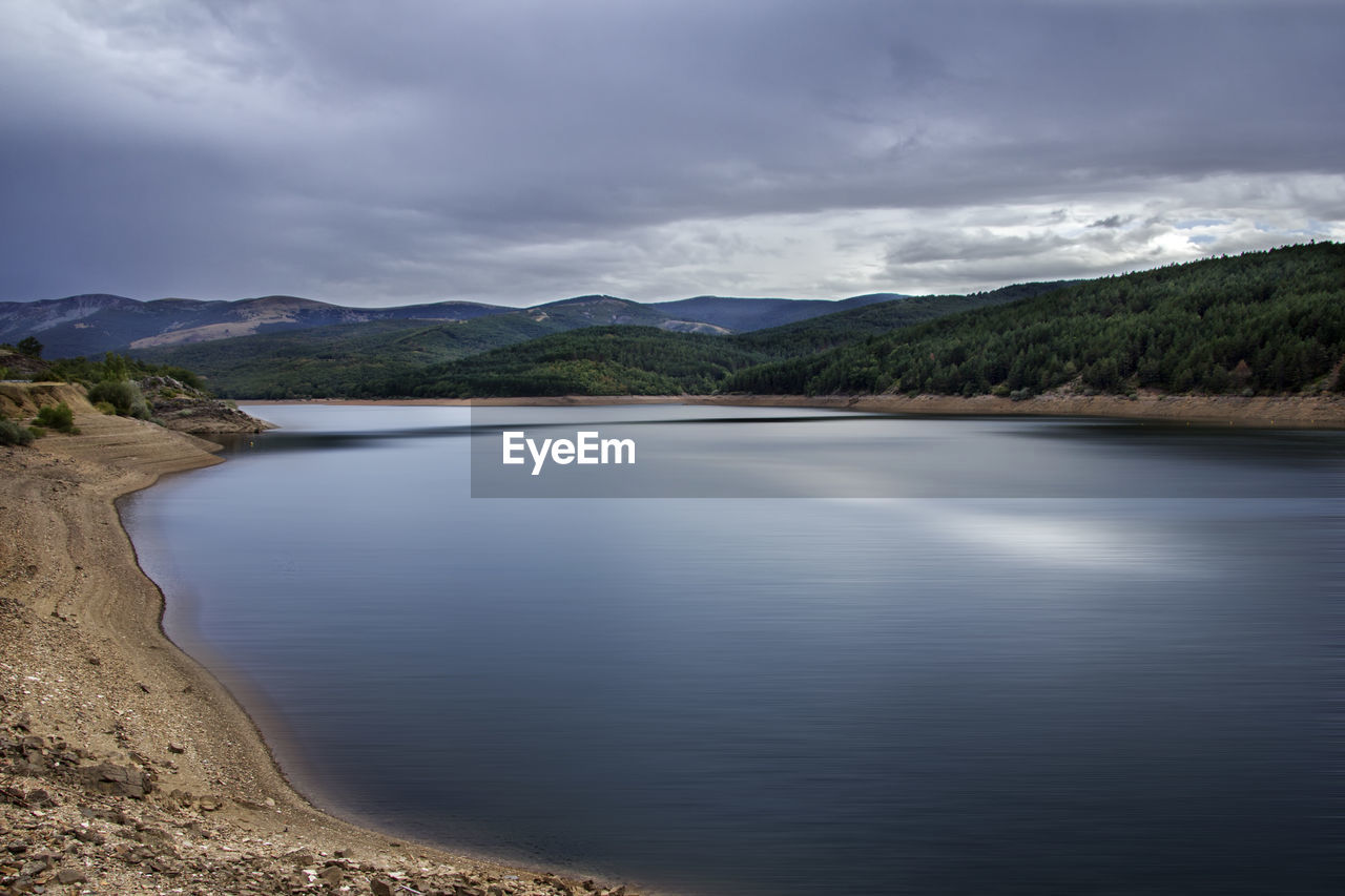 Scenic view of lake and mountains against sky