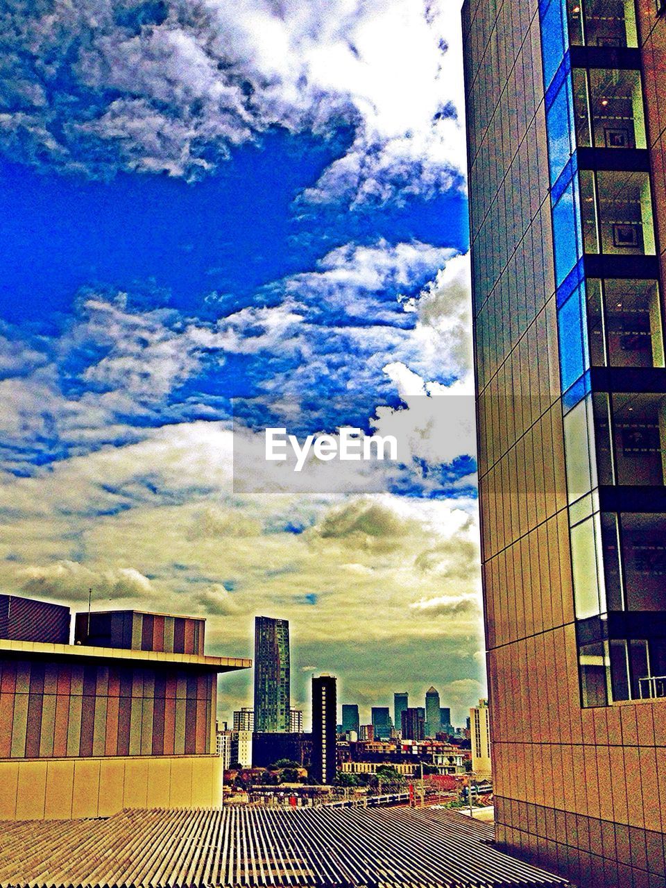 BUILDINGS AGAINST CLOUDY SKY