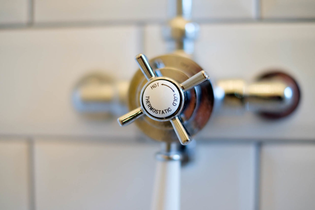 Close-up of knob on wall in bathroom