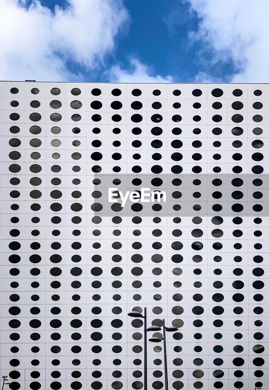 CLOSE-UP OF PATTERNED METAL AGAINST SKY