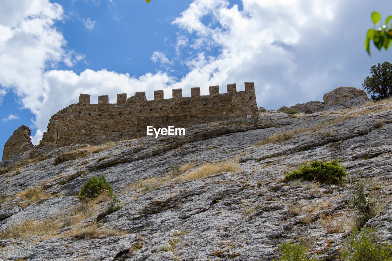 Low angle view of old ruins against sky