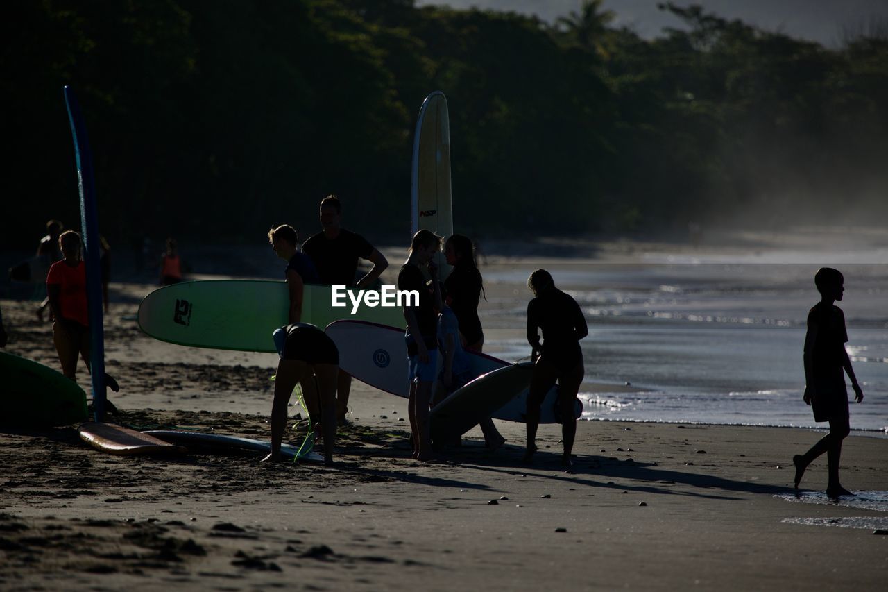 GROUP OF PEOPLE PLAYING ON BEACH