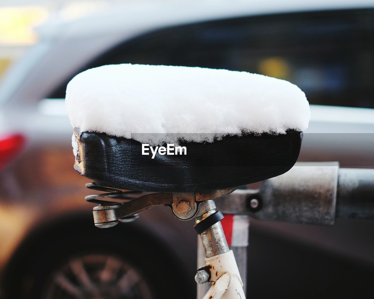 Close-up of snow covered bicycle seat