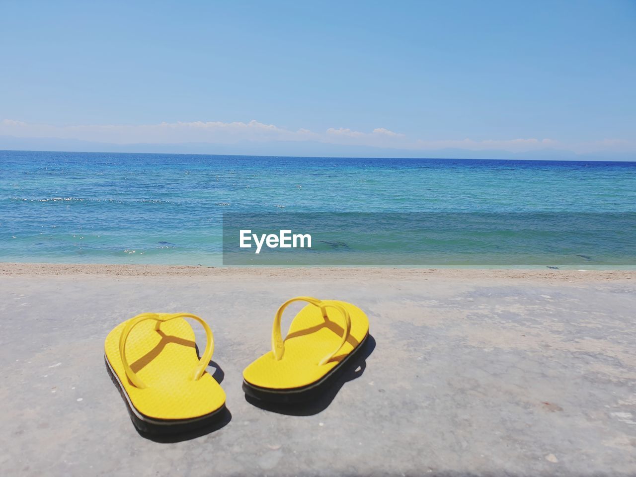 High angle view of shoes on beach against sea