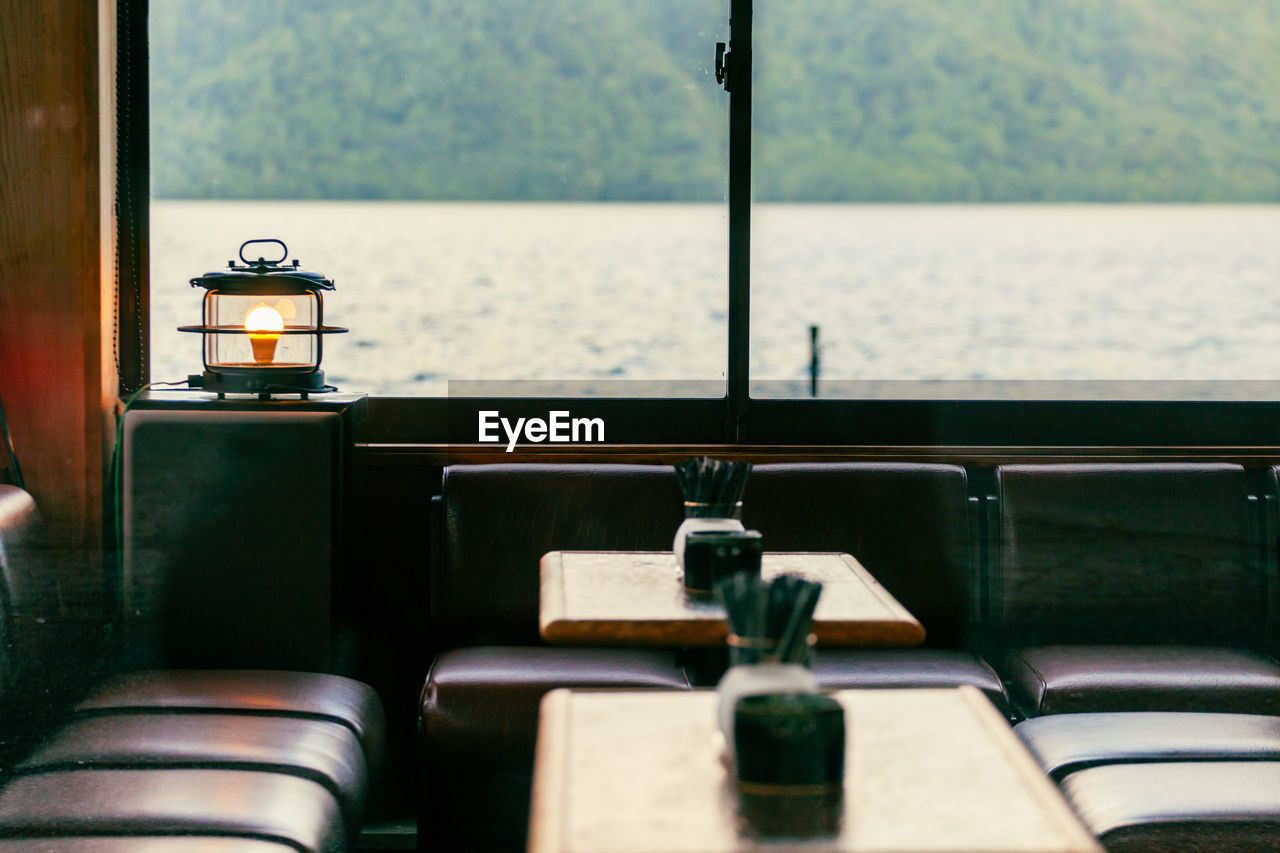 View of the water and mountain from inside a cozy lakeside restaurant