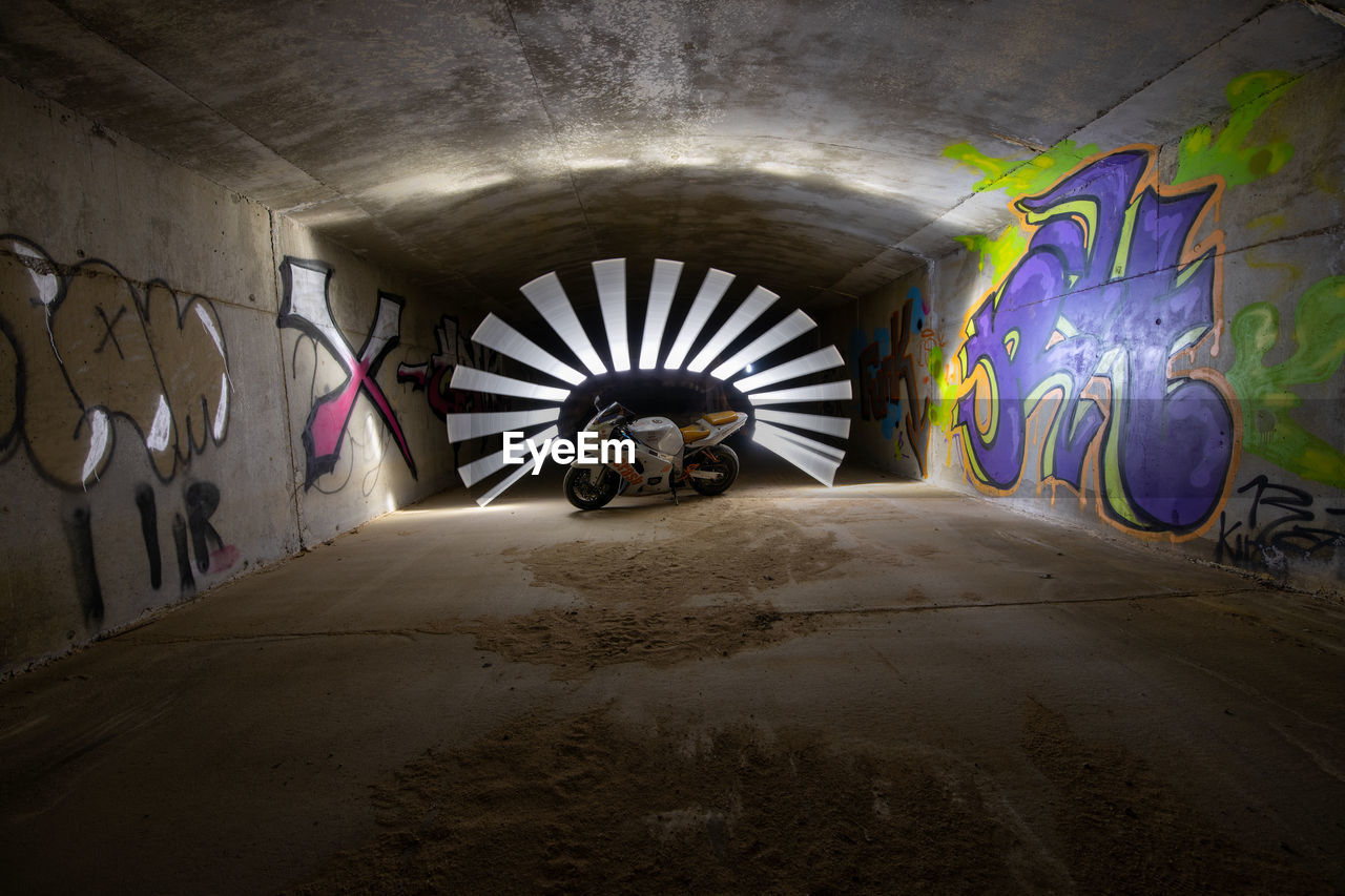 GRAFFITI ON ILLUMINATED TUNNEL