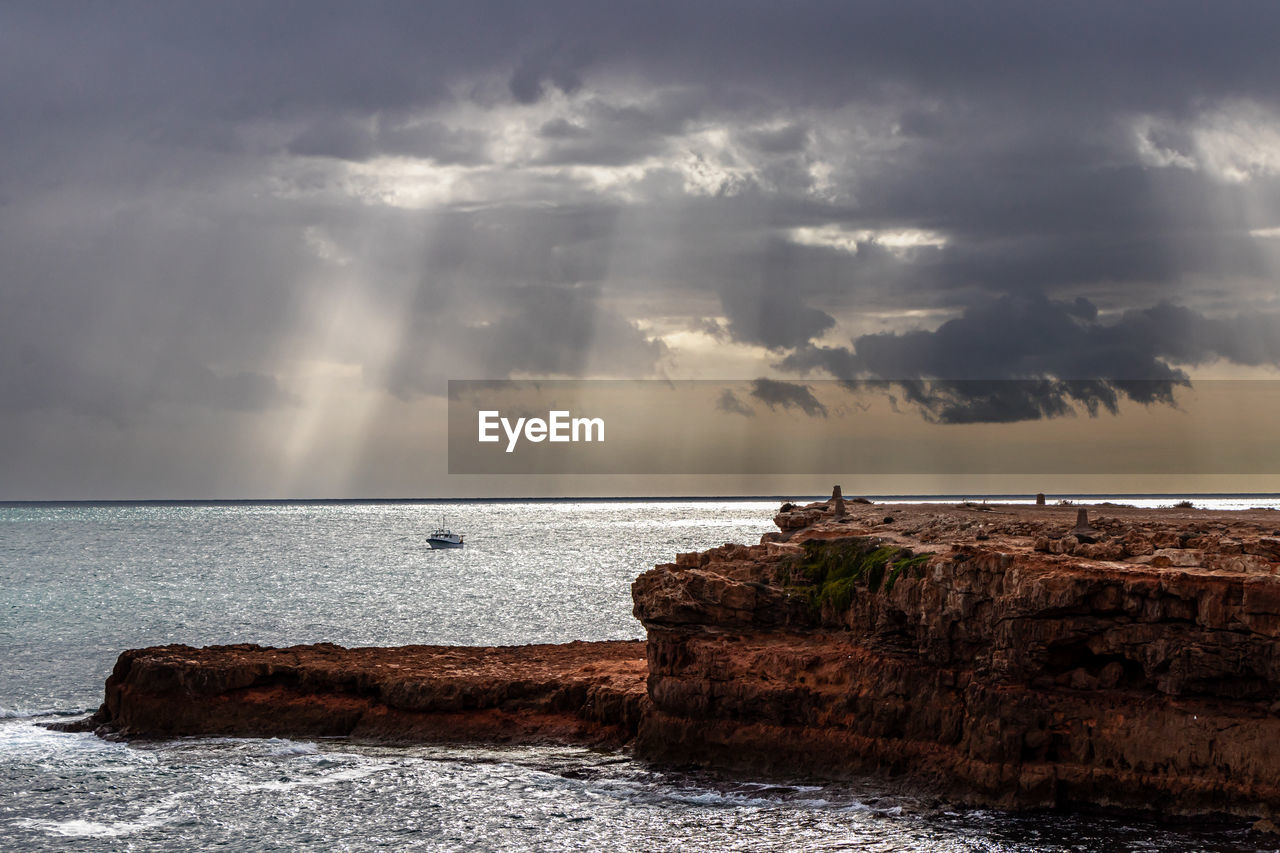 water, sky, sea, cloud, ocean, wave, horizon, shore, coast, land, beauty in nature, rock, nature, environment, beach, scenics - nature, morning, sunlight, body of water, dusk, storm, reflection, dramatic sky, horizon over water, wind wave, landscape, seascape, travel, travel destinations, tranquility, cloudscape, outdoors, no people, storm cloud, coastline, sunrise, tranquil scene, motion, overcast, tourism, architecture, cliff, vacation, trip, sun, holiday, sunbeam, idyllic, moody sky, bay