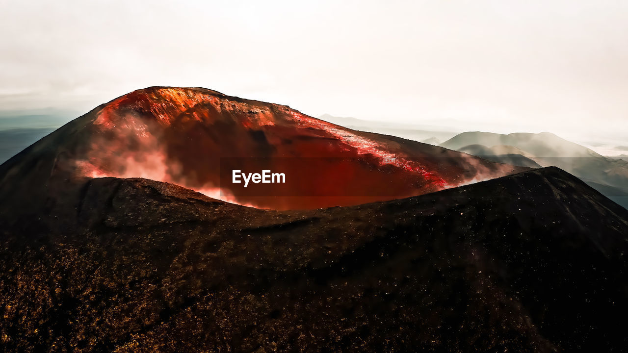 volcano, mountain, landscape, geology, environment, lava, beauty in nature, land, nature, volcanic landscape, active volcano, sky, erupting, scenics - nature, smoke, non-urban scene, power in nature, no people, travel destinations, volcanic crater, sunrise, cloud, outdoors, travel, lava dome, dawn, physical geography, stratovolcano, volcanic rock, heat, volcanic activity, cinder cone, ash