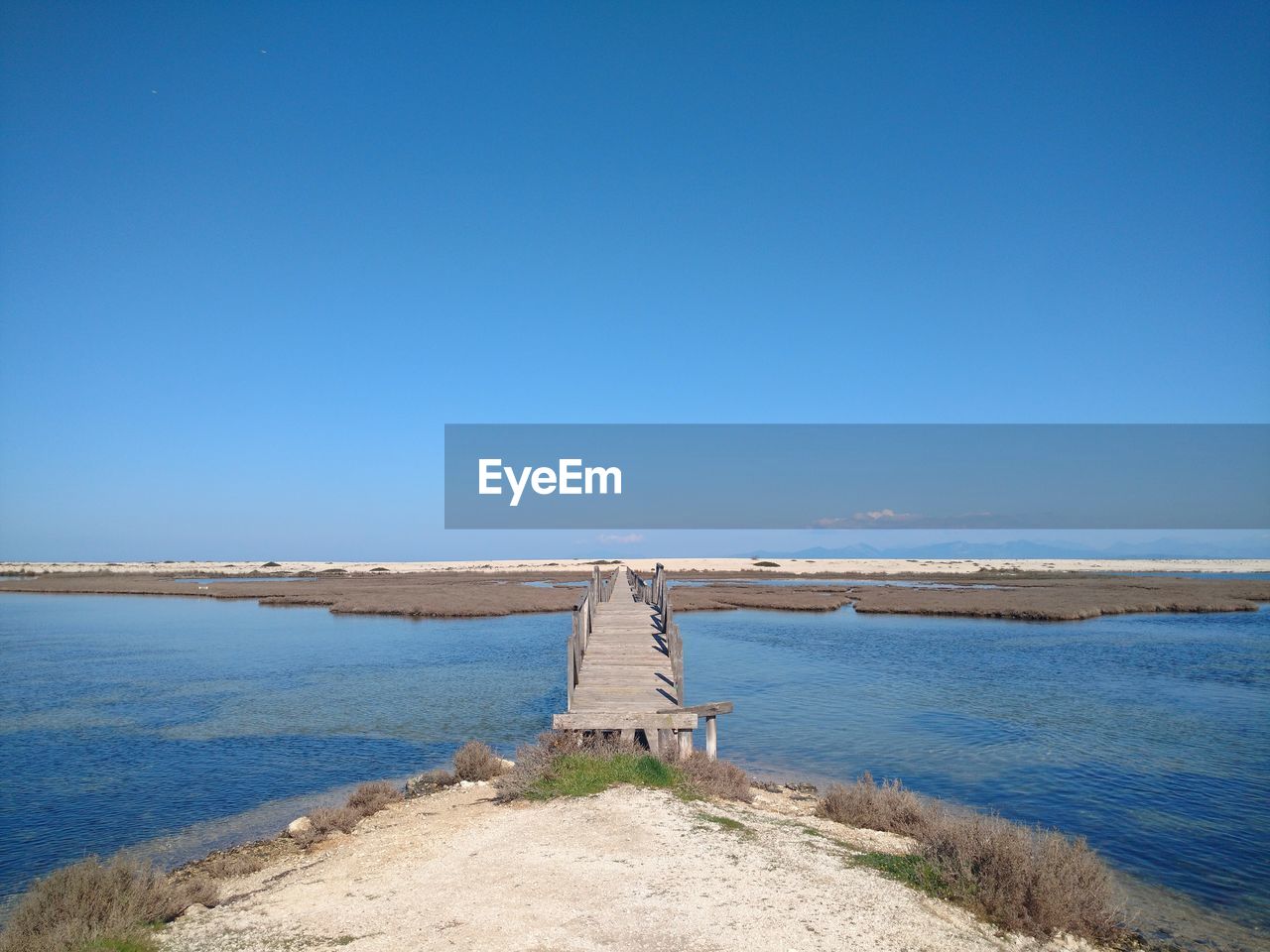 Scenic view of sea against clear blue sky