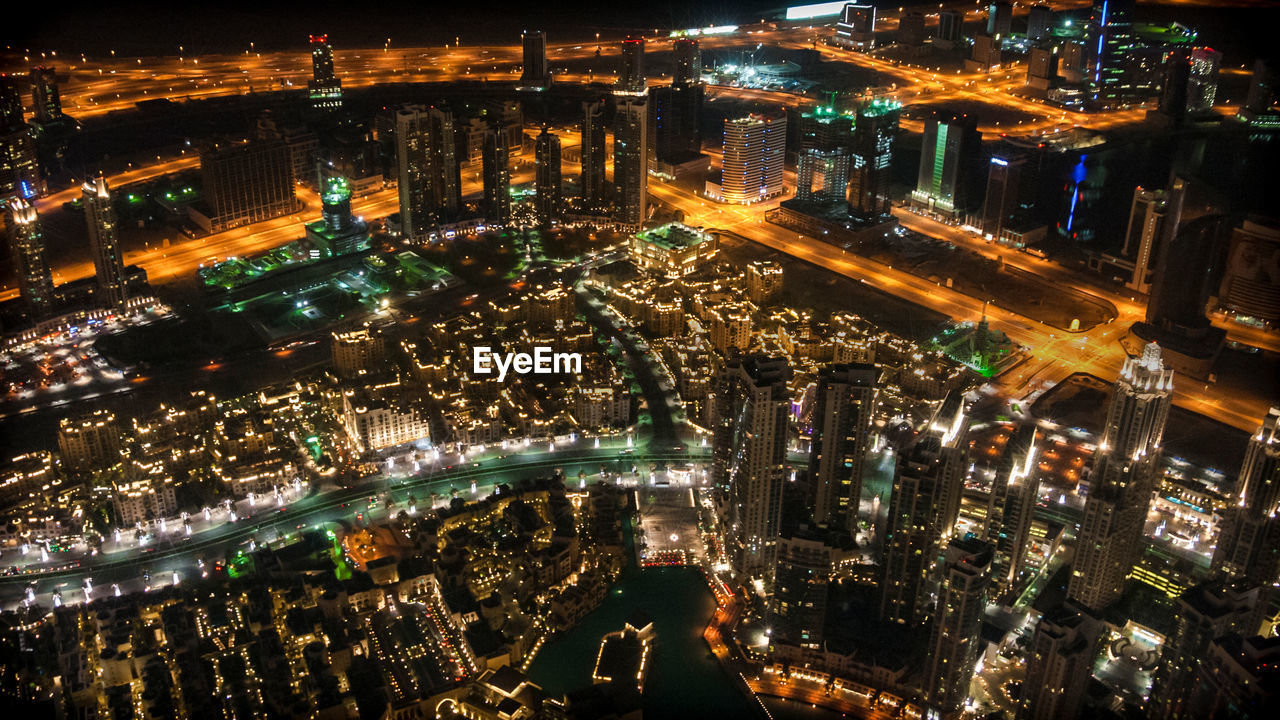 High angle view of city lit up at night