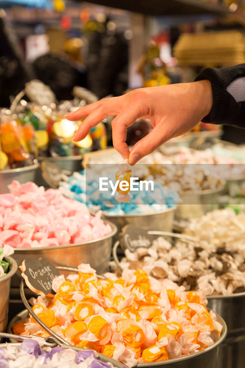 MIDSECTION OF PERSON PREPARING FOOD AT MARKET