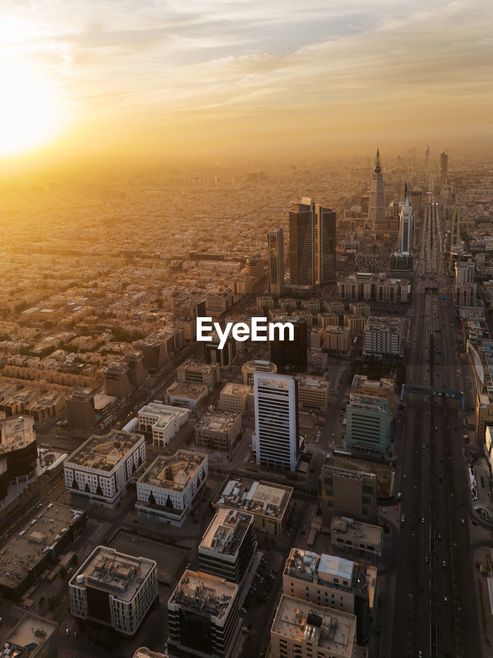 high angle view of buildings in city during sunset