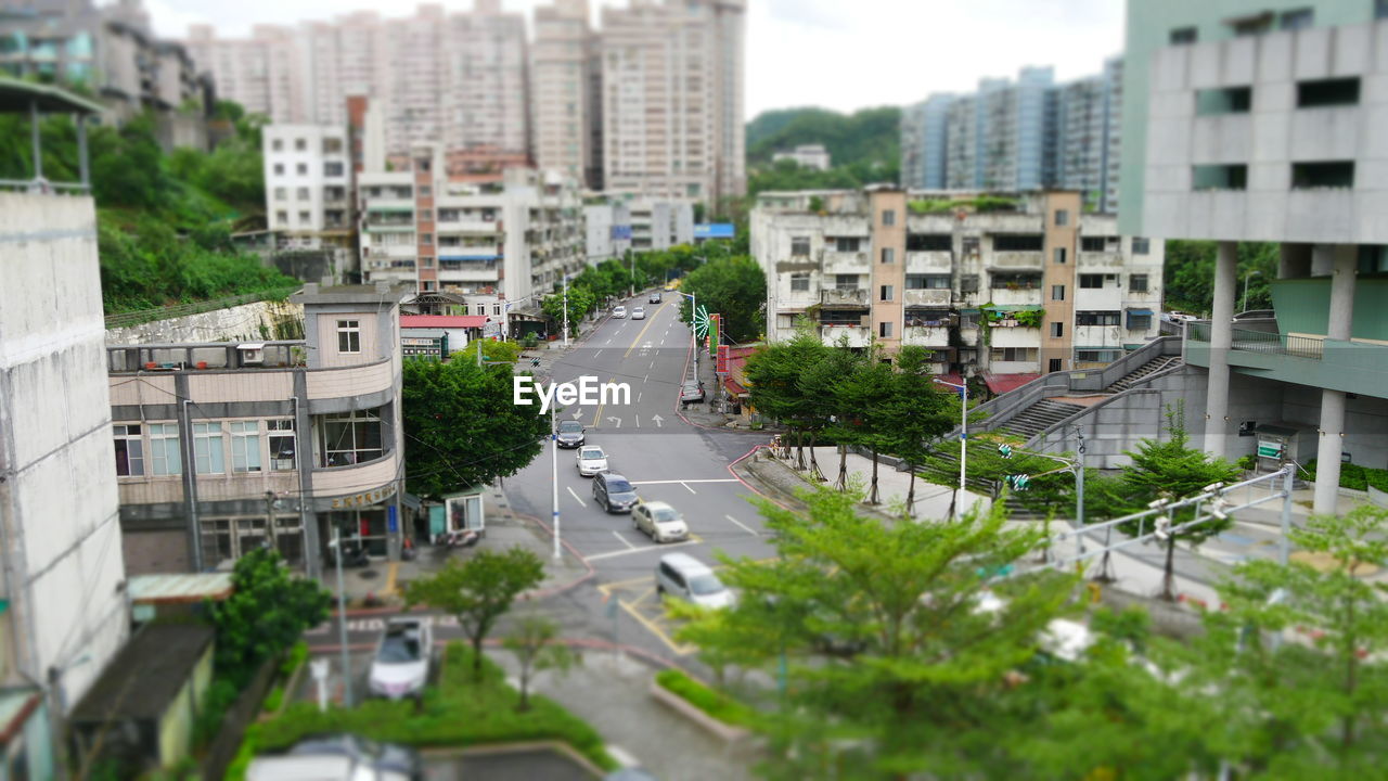 HIGH ANGLE VIEW OF STREET AMIDST BUILDINGS