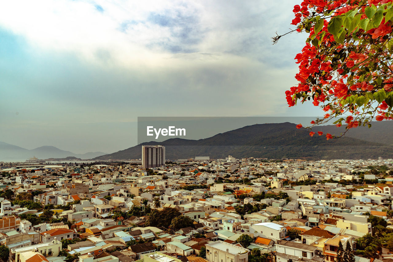 TOWNSCAPE BY MOUNTAINS AGAINST SKY