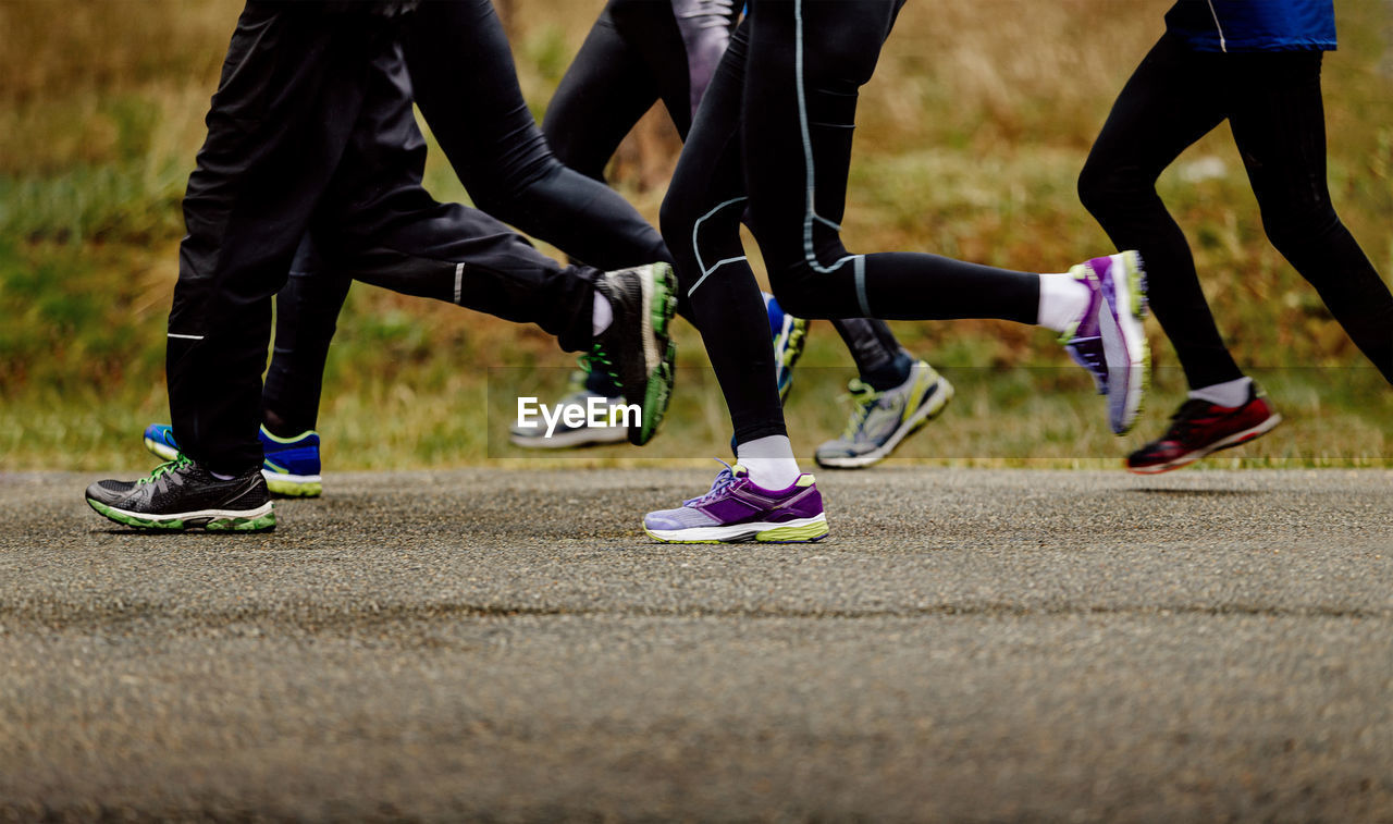 Low section of people running on road