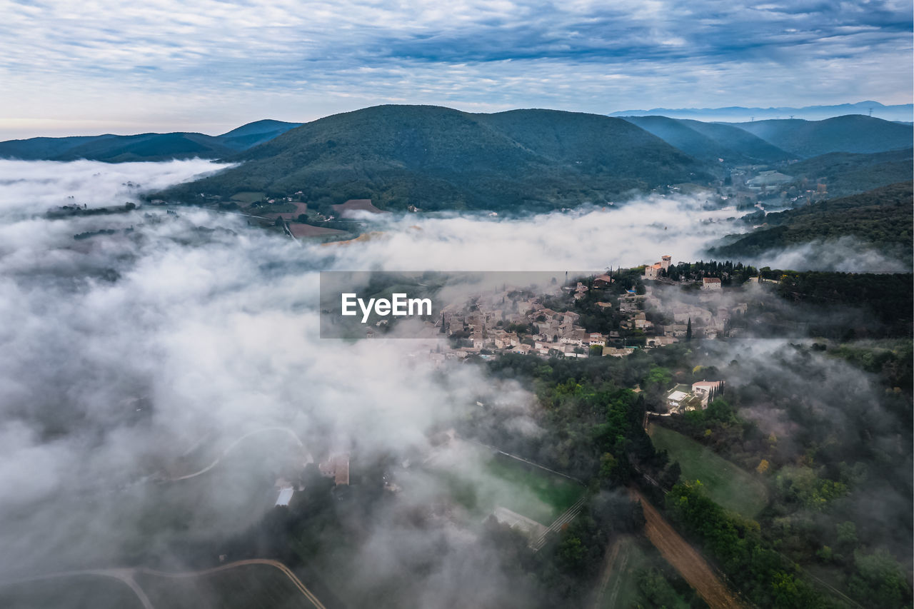 Panoramic view of the old village of mirmande. aerial photo in the morning in the thick fog rising 