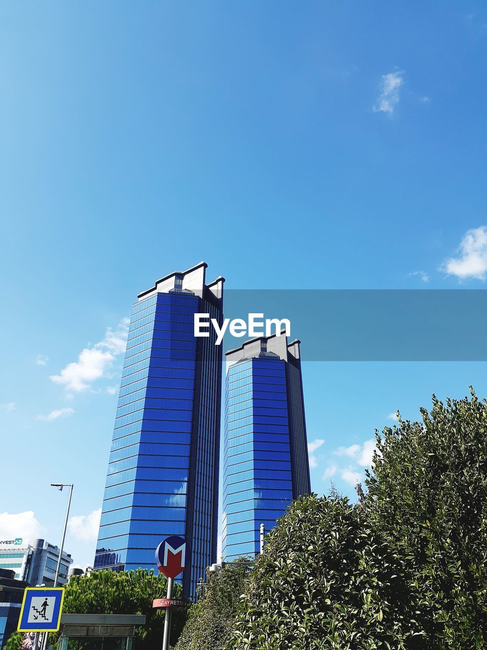 LOW ANGLE VIEW OF BUILDING AGAINST BLUE SKY