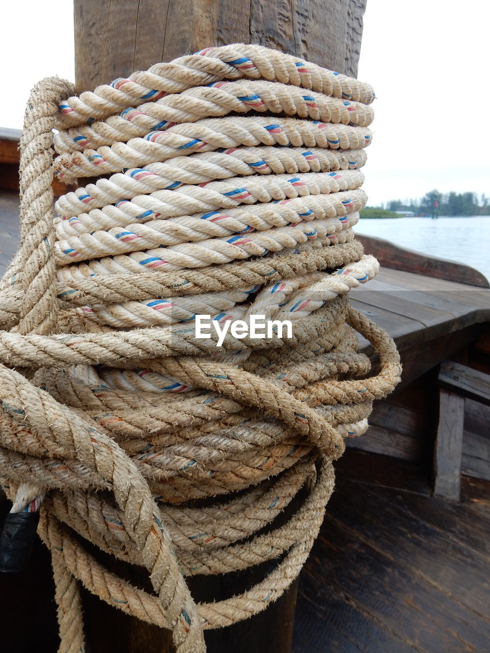 Close-up of rope tied on bollard at boat deck