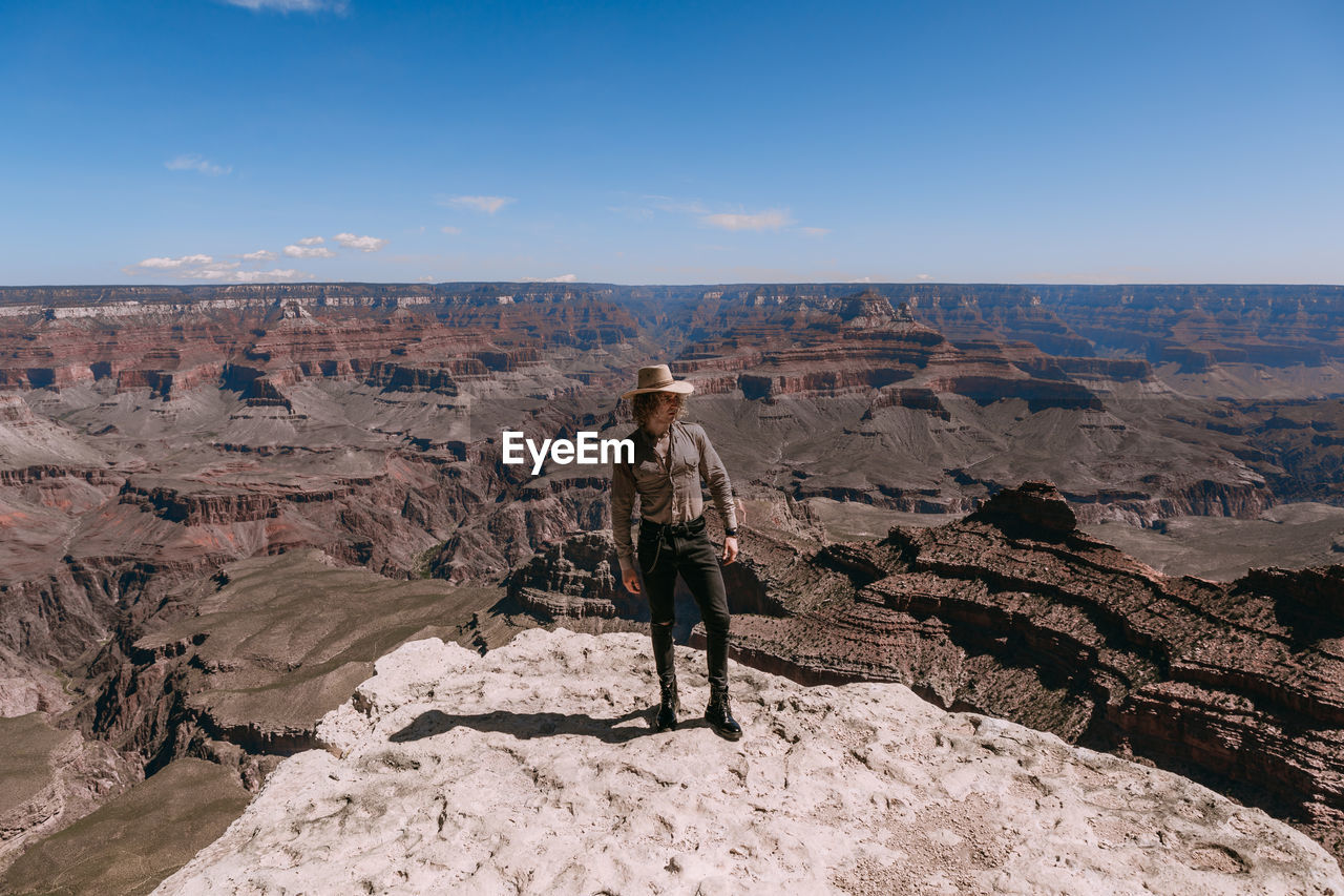 FULL LENGTH OF MAN STANDING ON ROCKS