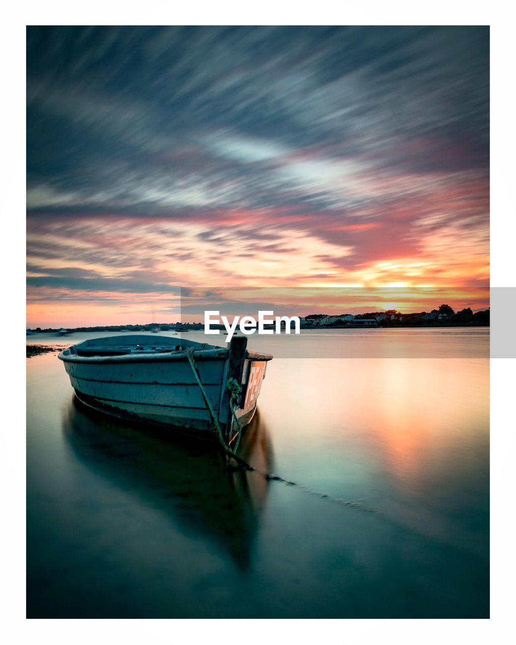 BOAT MOORED IN SEA AGAINST SKY