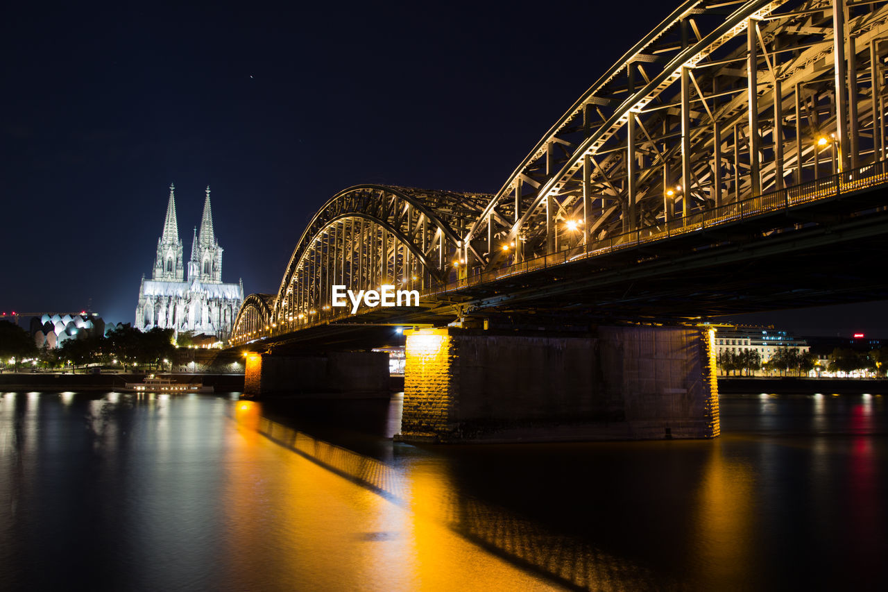 View of the old hohenzollern bridge, the skyline and a bright, cologne at night - germany,