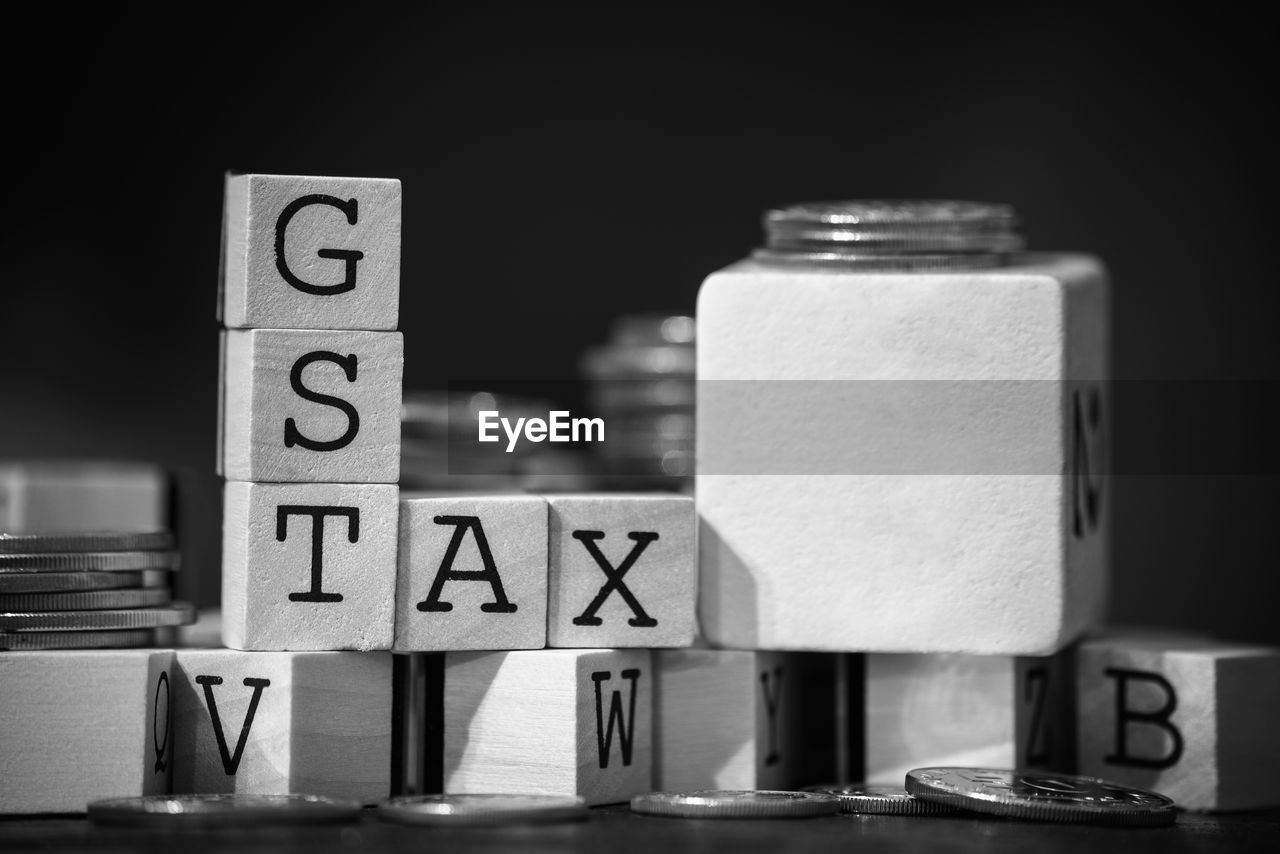 Close-up of gst text on wooden blocks