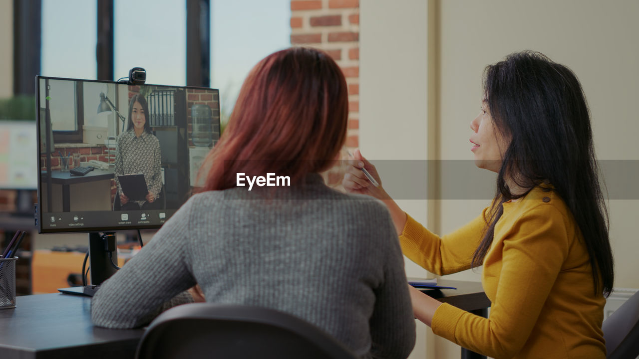 Businesswomen doing video call on desktop pc