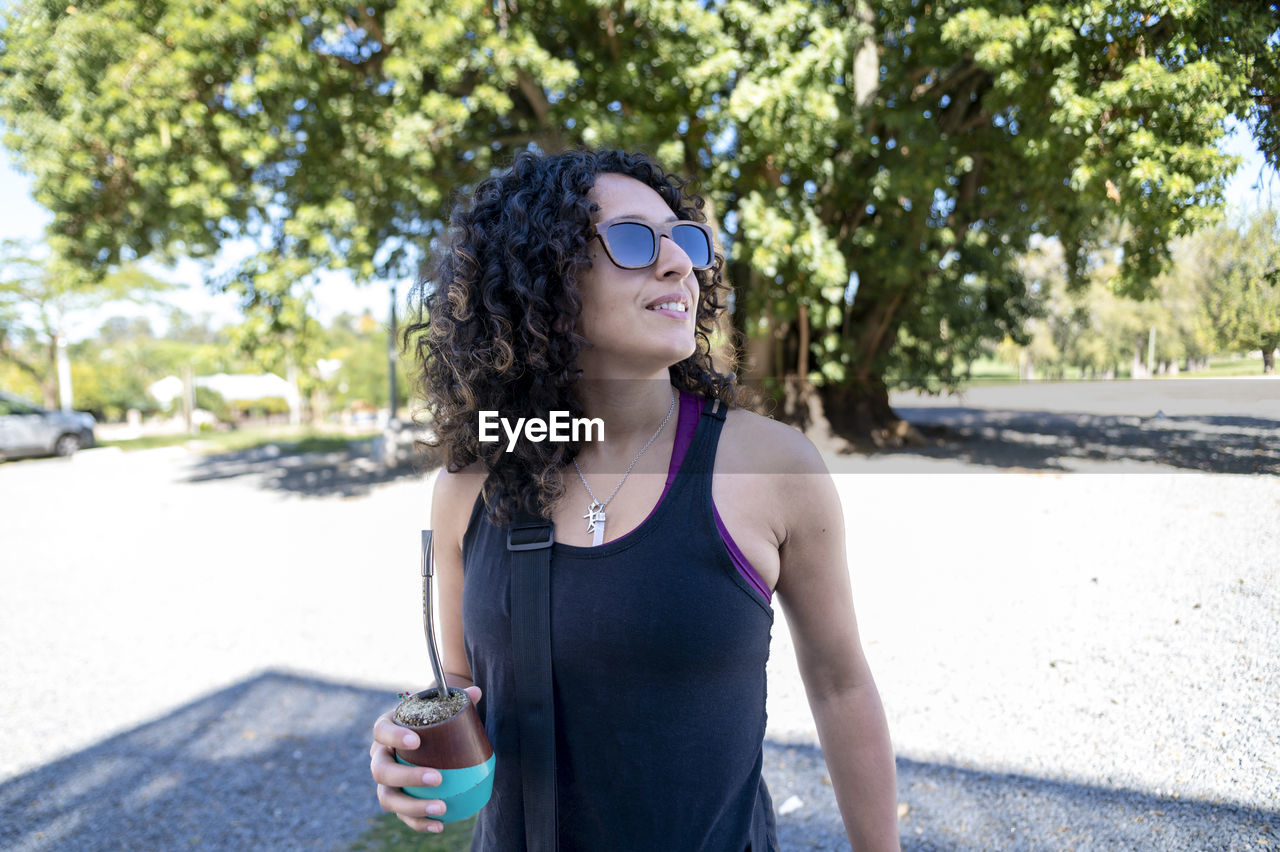 Tourist woman drinking a mate while exploring outdoors.