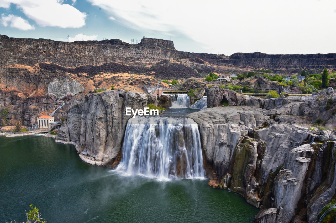 waterfall, water, scenics - nature, environment, rock, beauty in nature, nature, body of water, travel destinations, cliff, travel, water feature, landscape, land, tourism, rock formation, mountain, sky, motion, terrain, sea, outdoors, no people, non-urban scene, canyon, cloud, plant, ravine, environmental conservation, tree, trip, holiday, vacation, coast, long exposure